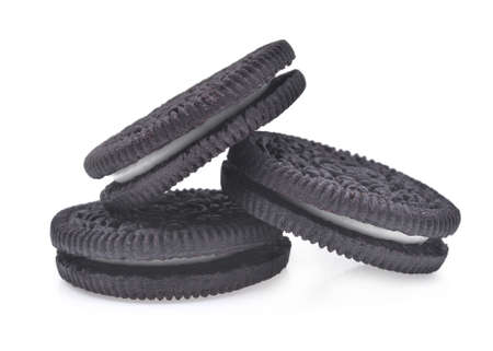 three sandwich chocolate cookies with cream isolated on white backgroundの写真素材