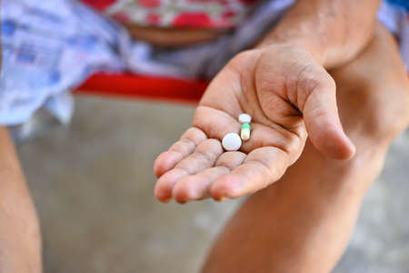old lady hand holding pills and tablets,for Health in selective focusの写真素材