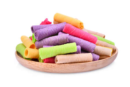 pile of colorful coconut-biscuit curl, thai dessert in wooden plate isolated on white backgroundの写真素材