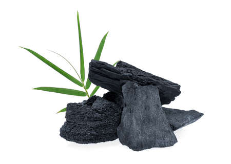 wood charcoal with bamboo leaf isolated on white backgroundの写真素材
