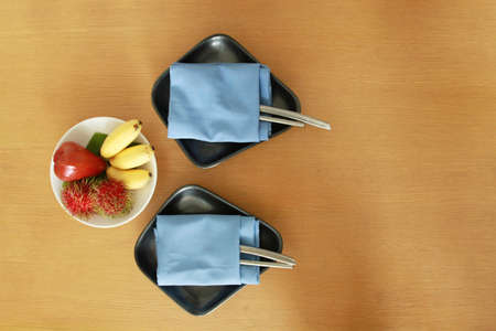 mixed fruit on table setting for two person