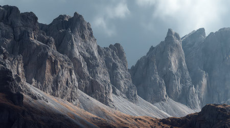 A stunning view of majestic rocky mountains under a dramatic cloudy sky. The rugged terrain showcases unique geological features, creating a serene atmosphere for nature enthusiasts.の素材