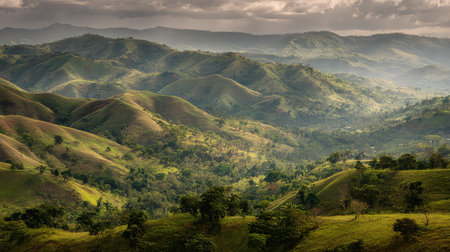 This breathtaking landscape features rolling hills adorned with lush greenery under a dramatic sky. The serene environment invites exploration and relaxation, showcasing nature's beauty.の素材