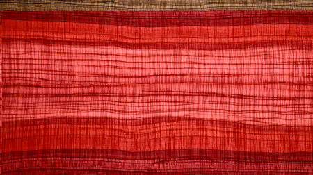 This abstract textile pattern showcases vibrant red hues with intricate textured lines. Perfect for art, design projects, or as a stylish backdrop.の素材