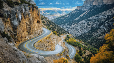 A captivating view of a winding mountain road set against a backdrop of rugged terrain and vibrant autumn foliage, inviting exploration and adventure.の素材
