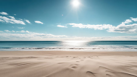 A stunning beach scene featuring soft, golden sand stretching towards a calm ocean under a bright sun and clear blue skies, evoking tranquility and relaxation.の素材