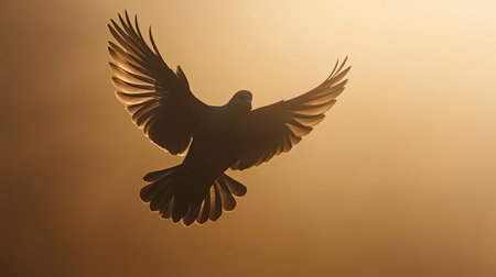 A stunning silhouette of a bird in mid-flight, showcasing its graceful wings against a soft golden sunset. This serene image captures the essence of freedom and natural beauty.の素材
