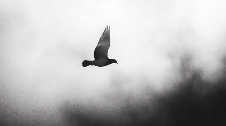 A beautiful silhouette of a bird soaring through a soft cloudy sky, epitomizing the essence of freedom and elegance in nature's serene atmosphere.の素材