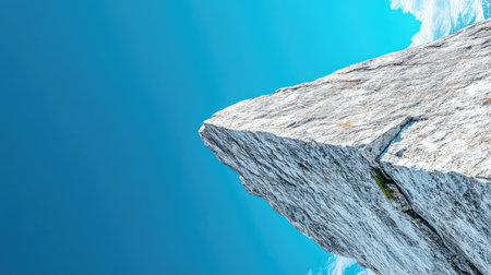 A striking rock formation towers against a bright blue sky dotted with soft clouds, creating an enchanting outdoor landscape perfect for nature lovers.の素材