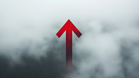 A striking red arrow breaks through a thick layer of soft white clouds, symbolizing upward movement and inspiration in a serene and abstract landscape.の素材