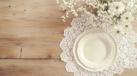 This beautiful image captures an elegant table setting featuring a vintage plate, fresh flowers, and lace detail on a rustic wooden surface, creating a serene atmosphere.の素材