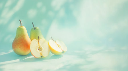 A vibrant still life featuring fresh pears and sliced apples, beautifully arranged on a soft blue surface. Gentle shadows create an elegant backdrop, emphasizing the natural colors and textures of the fruit.の素材