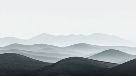 A serene landscape capturing soft rolling hills in muted monochrome tones, evoking a sense of tranquility and peacefulness under a vast sky.の素材