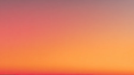 This image captures a serene gradient sunrise sky, showcasing soft pink, orange, and blue hues blending beautifully. Perfect for conveying tranquility and natural beauty.の素材
