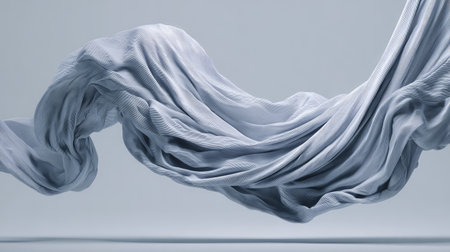 This striking image showcases an elegantly flowing piece of gray fabric, effortlessly capturing movement and texture, ideal for artistic projects and backgrounds.の素材