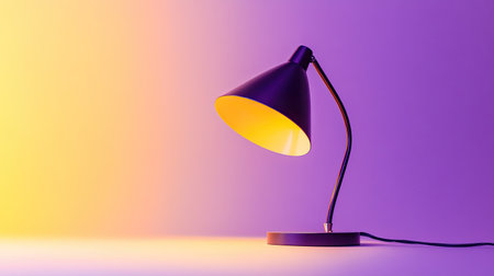This image features a stylish desk lamp emitting a soft yellow light against a beautiful gradient background of purple and yellow hues, perfect for modern interiors.の素材