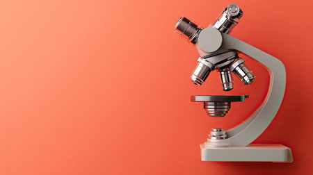 This image features a modern laboratory microscope set against a vibrant coral background, symbolizing innovation and scientific exploration for educational settings.の素材