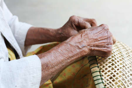 Thai Old woman weaving bamboo basketsの写真素材