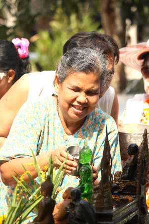 Elderly Bathing Buddha in songkran thailand festival のeditorial素材