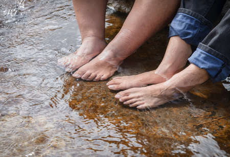Dipping feet in water on a warm summer dayの写真素材