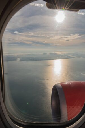 Sunrise on a plane windowの写真素材