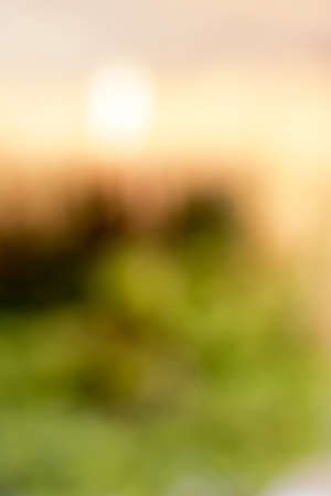 Mountains, sun and grass blur the beauty of nature.の写真素材