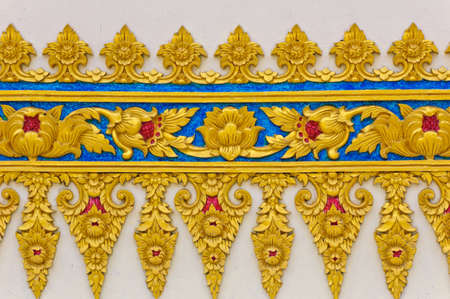 Thai floral sculpture on temple wallの写真素材