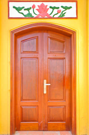 Wooden door on yellow wall