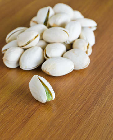 Roasted shelled pistachio on wooden background
