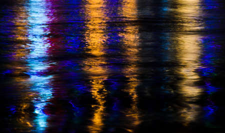 Colored lights on water reflectionの写真素材