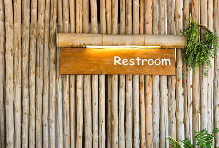 Restroom sign on wood backgroundの写真素材