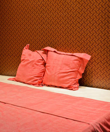 Colorful bed with beautiful wallpaperの写真素材