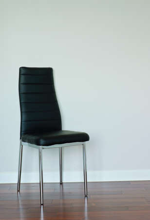 Black leather chair on blank wall の写真素材