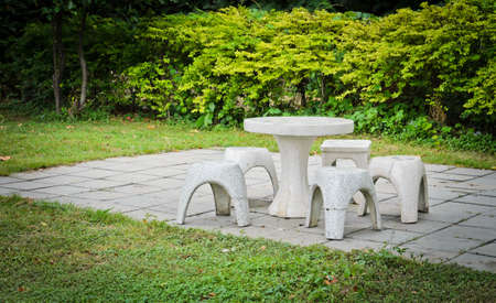White stone table and chair in the garden の写真素材