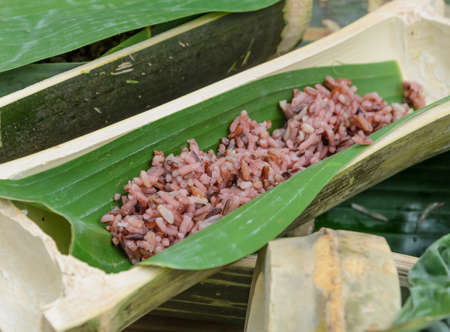 Red streamed rice in bamboo stalk