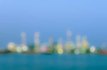 Abstract bokeh factory illuminated lights with reflection on waterの写真素材