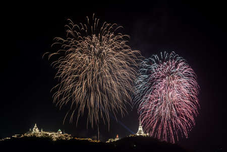 Colorful firework over  temple on hill, Thailand の写真素材