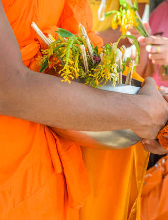 Monks receiving flower offering in Tak Bat Dok Mai or Flower Alms festival in Thailand の写真素材
