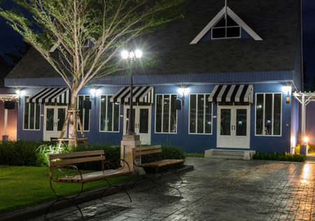 Garden bench in front of Dutch style house at nightのeditorial素材