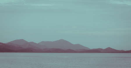Beautiful sunset over the mountain at Andaman sea Thailand. Vintage effect with soft focus.の写真素材