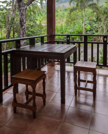 Wooden chair and table on terraceの写真素材