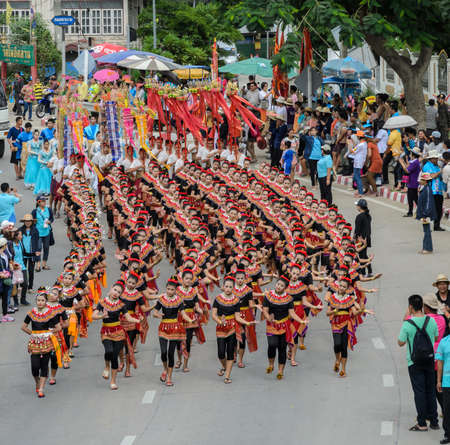 SUPHANBURI, THAILAND - JULY 12, 2014: Thai dancing parade of candle festival procession on The Buddhist Lent Day in Suphanburi, Thailand.のeditorial素材