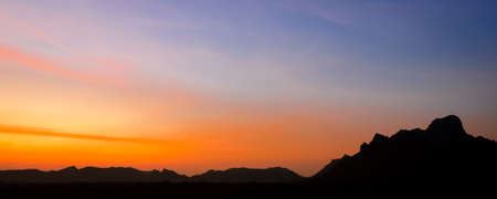 Beautiful sunset landscape with silhouette mountainの写真素材