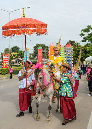 SUPHANBURI, THAILAND - JULY 12, 2014: Thai costume parade of candle festival procession on The Buddhist Lent Day in Suphanburi, Thailand.のeditorial素材