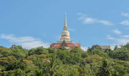 Buddhist temple with white pagoda on hill, Thailandの写真素材