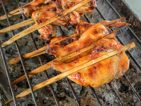 Grilled chicken on the stove, street food in Thailand.の写真素材