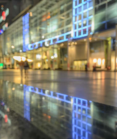 Blurred image of shopping mall with shining lights at nightの写真素材