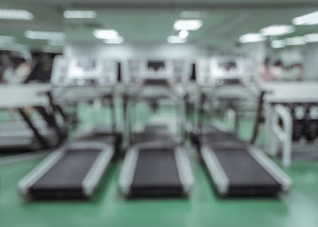 Interior of modern fitness center with equipment. Blur abstract background image in retro filtered color.の写真素材