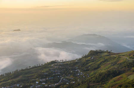 Panoramic view of mountain landscape with curve road at sunrise over sea of fog in Phetchabun, Thailandの写真素材