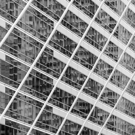 Abstract background image of blur exterior building with reflection on glass window. Black and white...